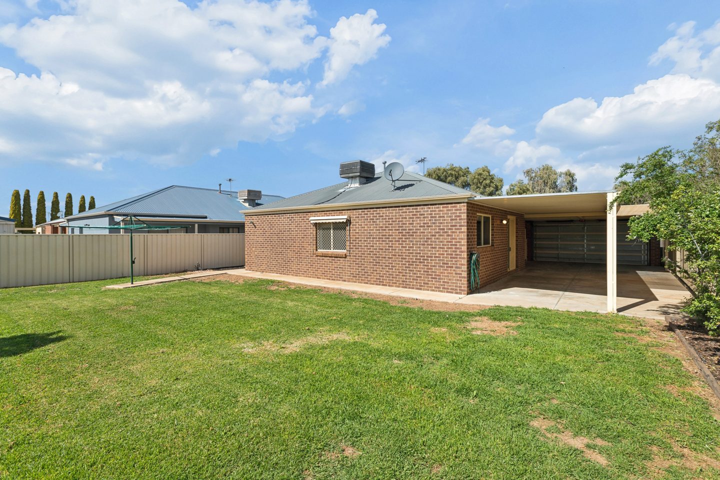 The backyard, rear facade and covered patio