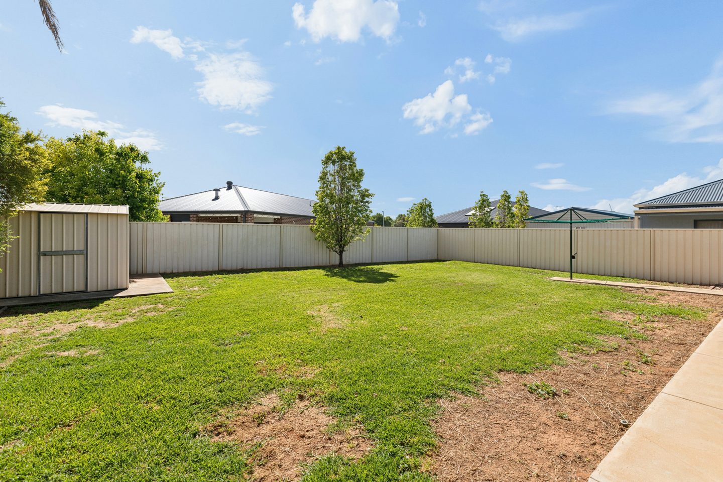 Rear lawn, garden shed and boundary fencing
