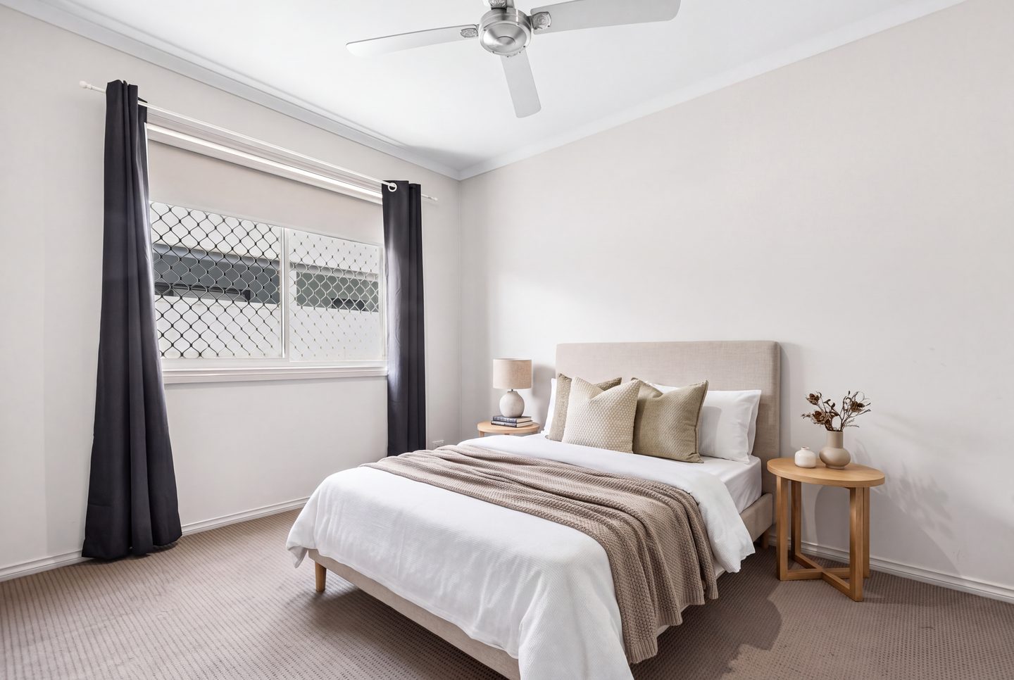 Bedroom with a ceiling fan and a large window